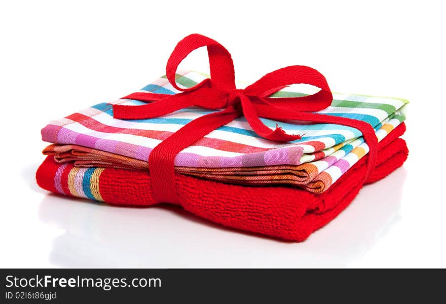 A red towel and a colored striped kitchen cloth packed as a gift. A red towel and a colored striped kitchen cloth packed as a gift