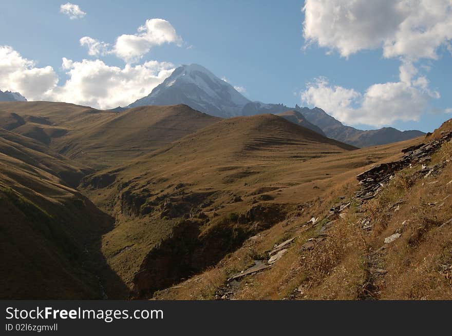 Mount Kazbeg (Mkhinvartsveli) view during hiking in Georgian mountains, Caucasian mountains. Mount Kazbeg (Mkhinvartsveli) view during hiking in Georgian mountains, Caucasian mountains