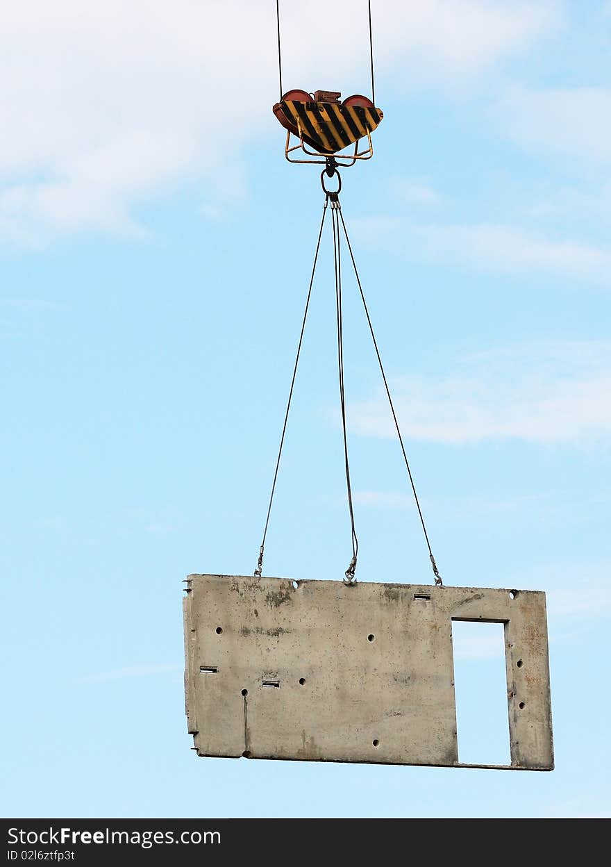 concrete block lifted by tower crane