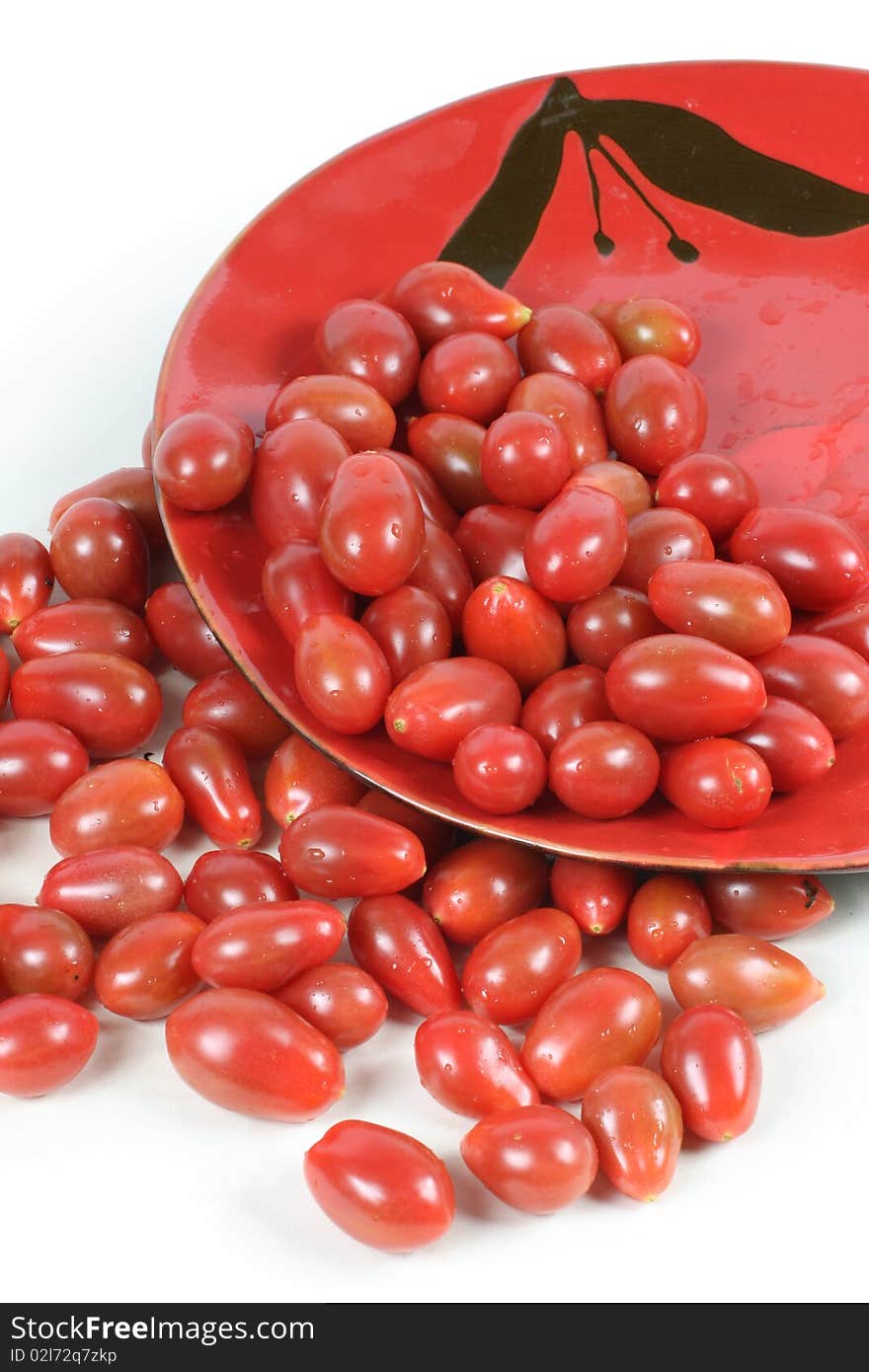 Small tomato on red plate