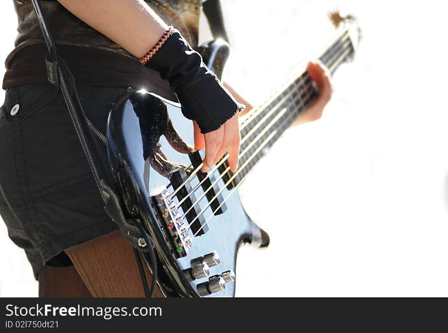 A musician playing guitar against a white background. A musician playing guitar against a white background.