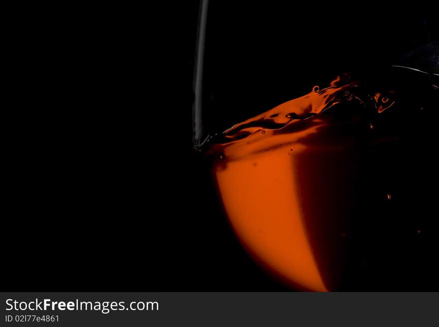 Red wine on the black background