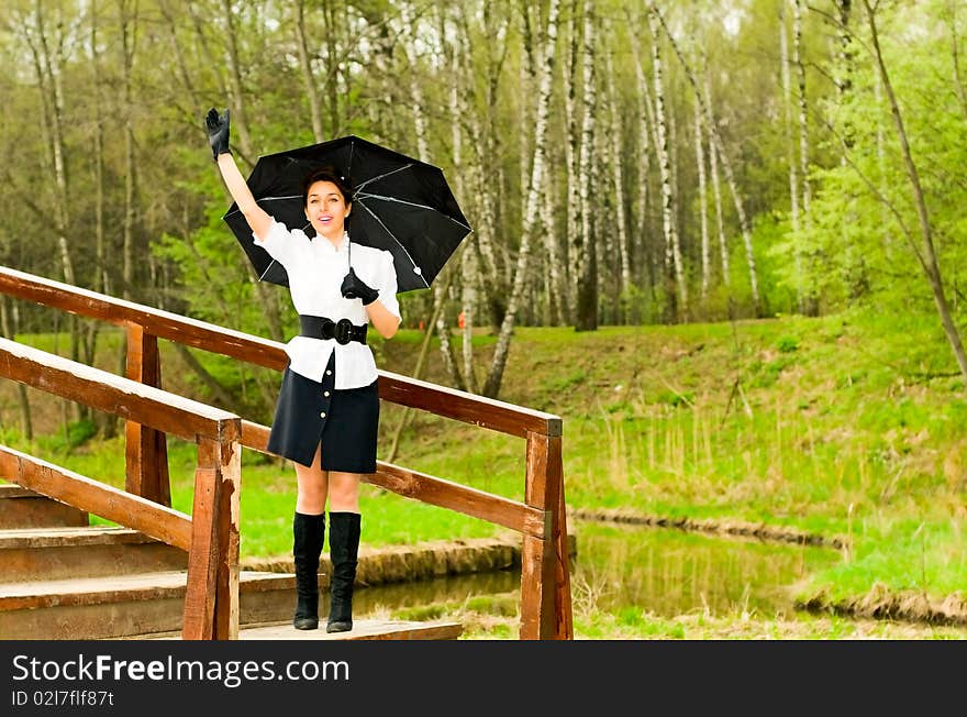 Young smiling woman waving hand in park. Young smiling woman waving hand in park