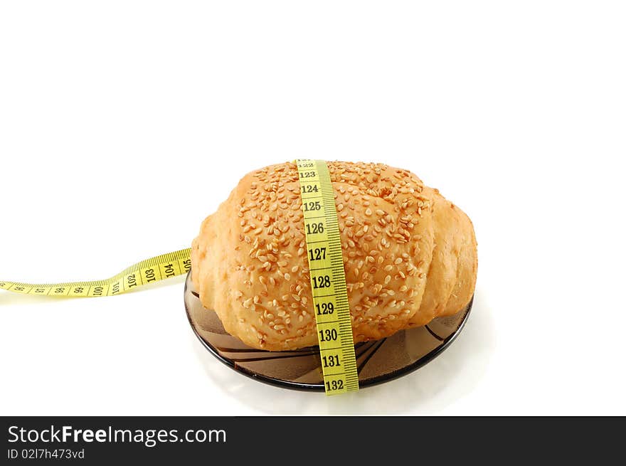 Bread with a centimeter tape isolated on a white background