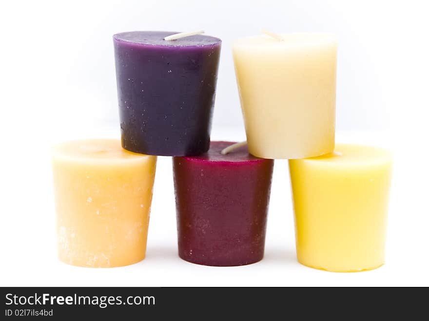 Pyramid of the five colored candles on a white background. Pyramid of the five colored candles on a white background