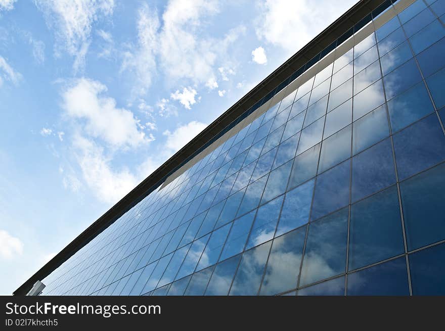 A building reflecting the blue sky on it's exterior. A building reflecting the blue sky on it's exterior