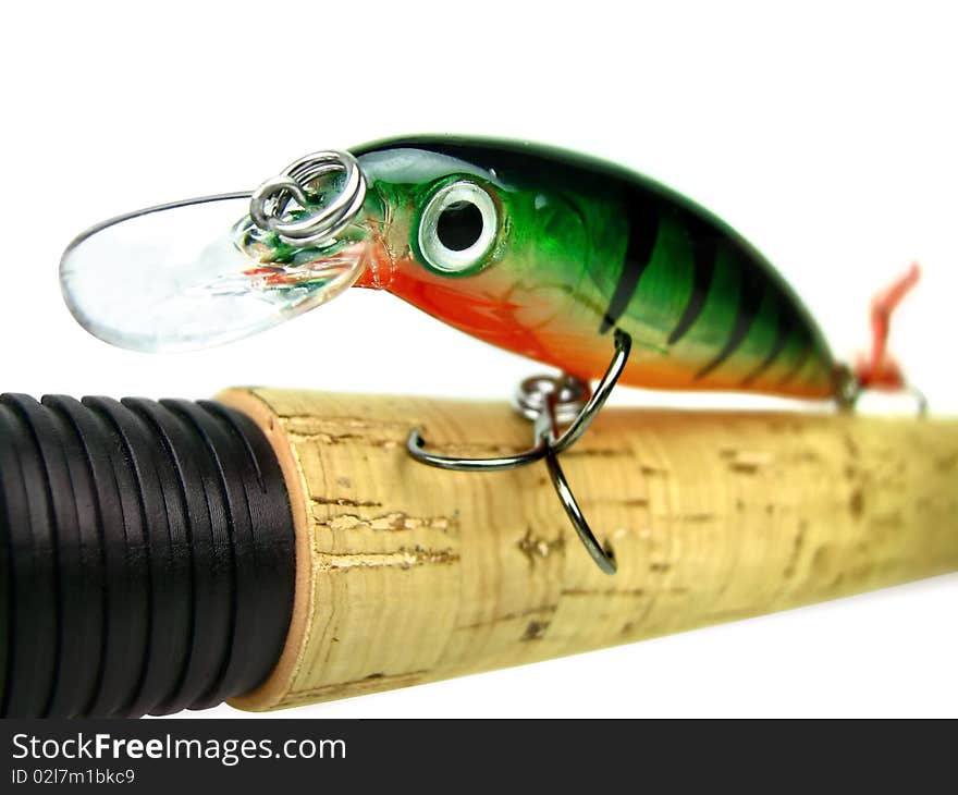 Fishing bait - wobbler on the handle spinning. Soft focus. Fishing bait - wobbler on the handle spinning. Soft focus.