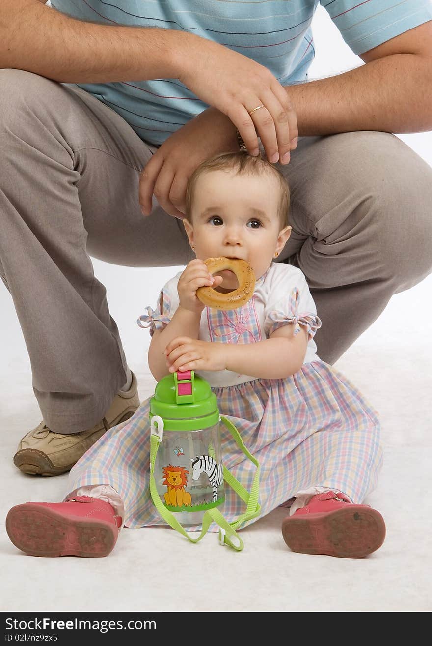 Portrait of baby girl over a dad's legs