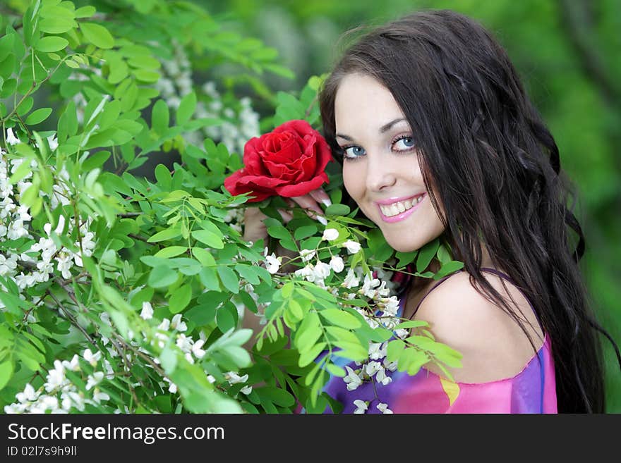 Pretty smiling girl relaxing outdoor in spring or summer flowers. Pretty smiling girl relaxing outdoor in spring or summer flowers