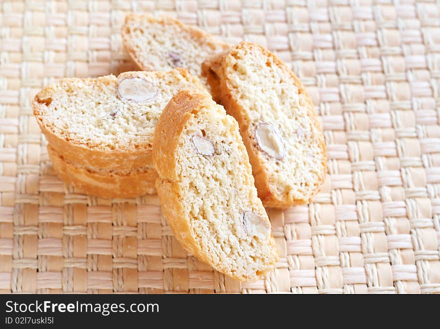 Stack of tasty almond biscotti cookies on woven placemat. Stack of tasty almond biscotti cookies on woven placemat