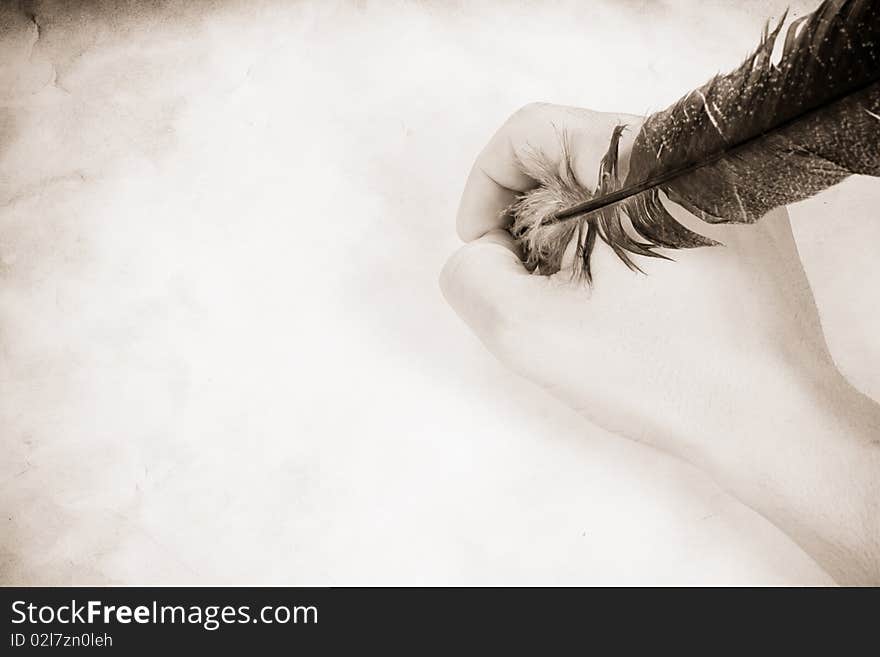 Vintage image of male hand holding the feather. Vintage image of male hand holding the feather