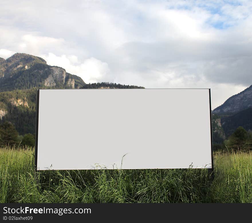 Advertising billboard with mountains on the background