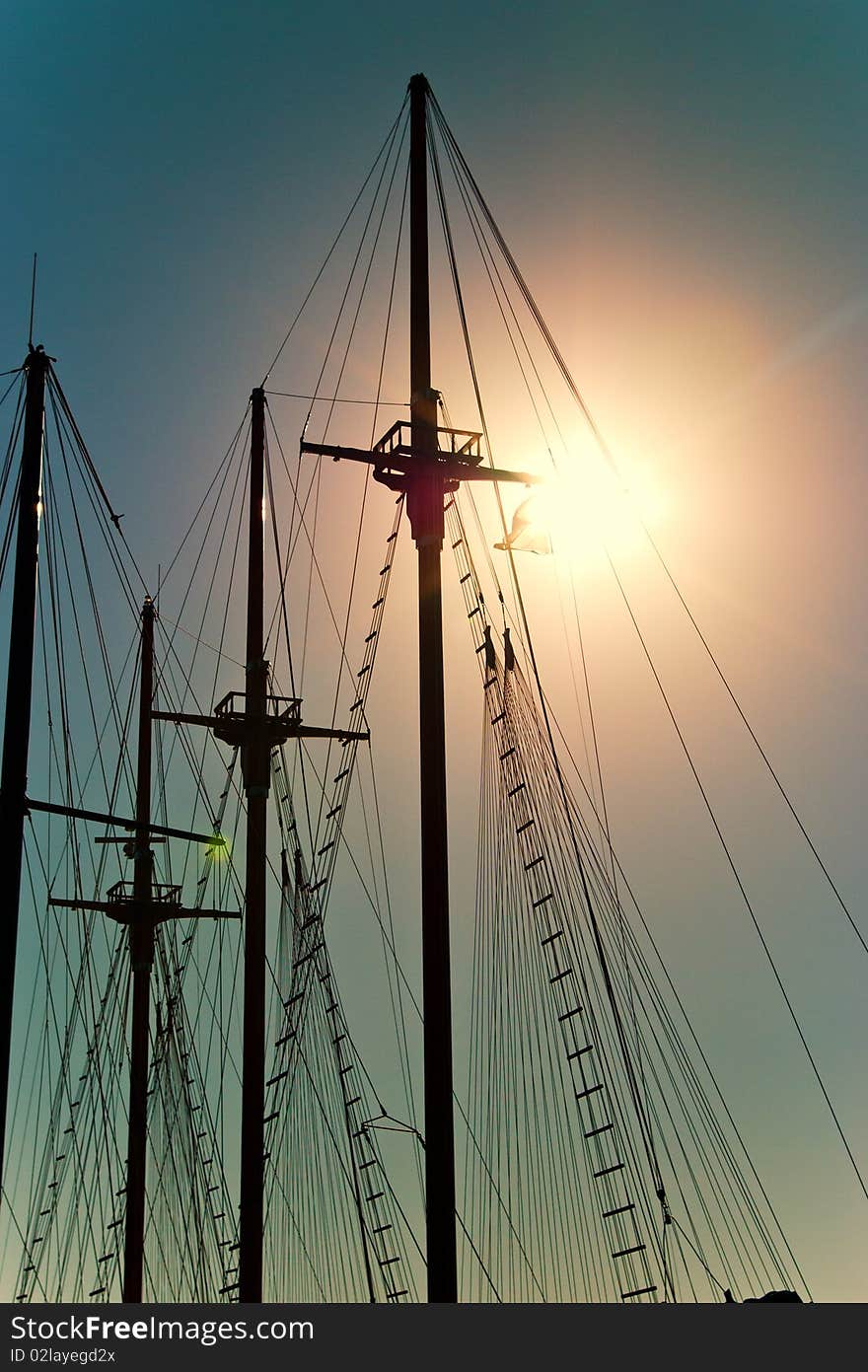 Ship masts on the sunrise sky