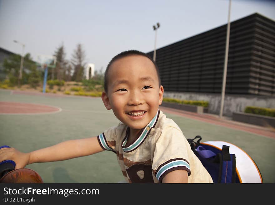 The asian boy is riding the bike with great fun. The asian boy is riding the bike with great fun