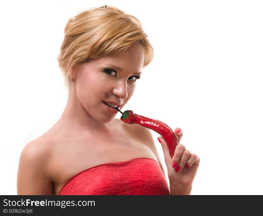 The seductive woman holds a red pepper. The seductive woman holds a red pepper