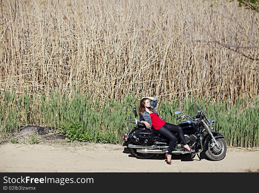 Portrait of a young girl on a motorcycle