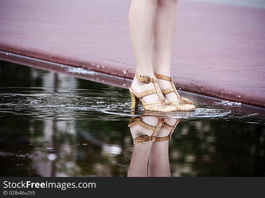 Feet in a puddle with reflecting