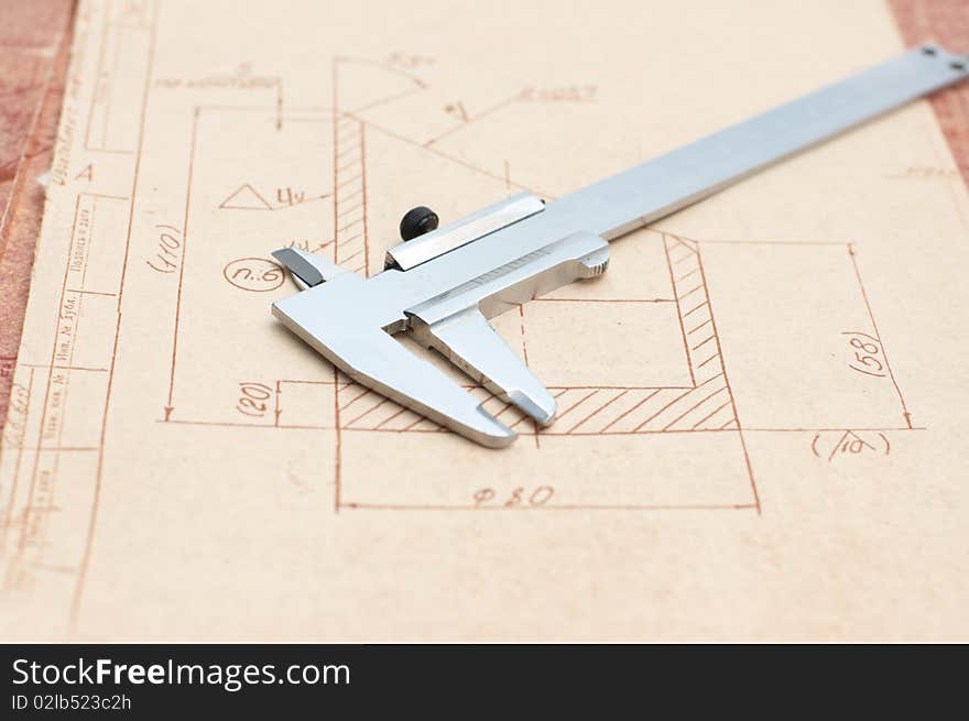 Workplace: Engineer drawing and  caliper