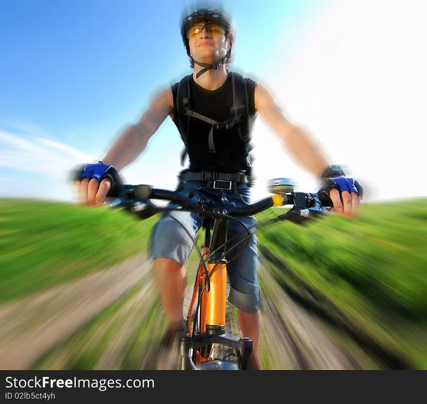 Dynamic composition with cyclist; warm lighting setup; attention - main focus is on the wheel and not on the face!. Dynamic composition with cyclist; warm lighting setup; attention - main focus is on the wheel and not on the face!