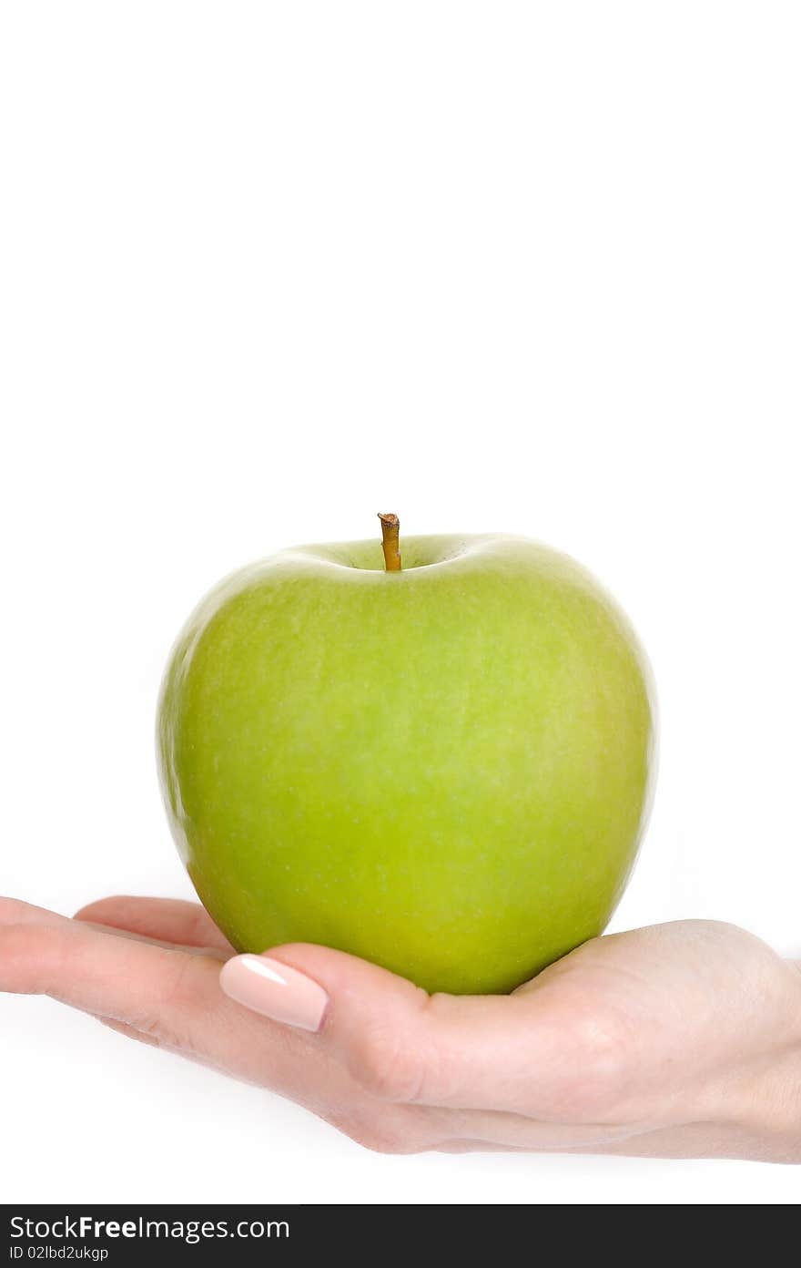 Green apple in a beautiful hand of woman with perfect nail manicure. white background