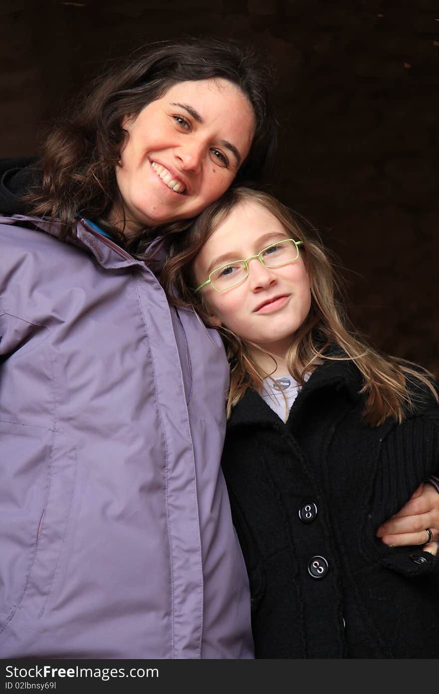 Mother holding daughter smiling together