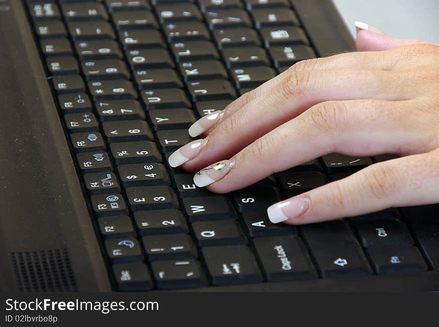 Girls hand working on a keyboard. Girls hand working on a keyboard