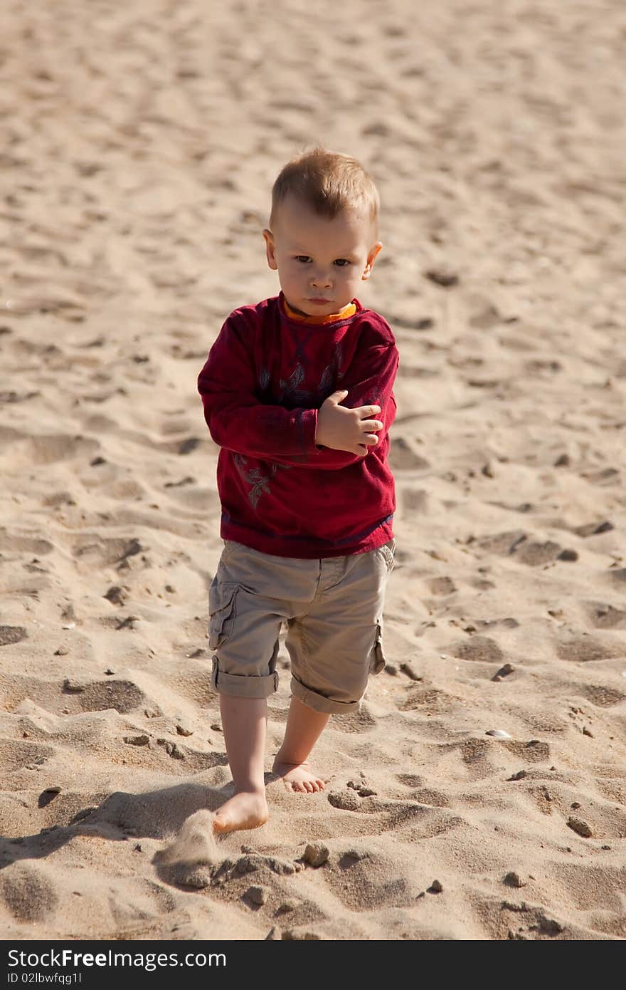 Small boy walking at the beach. Small boy walking at the beach