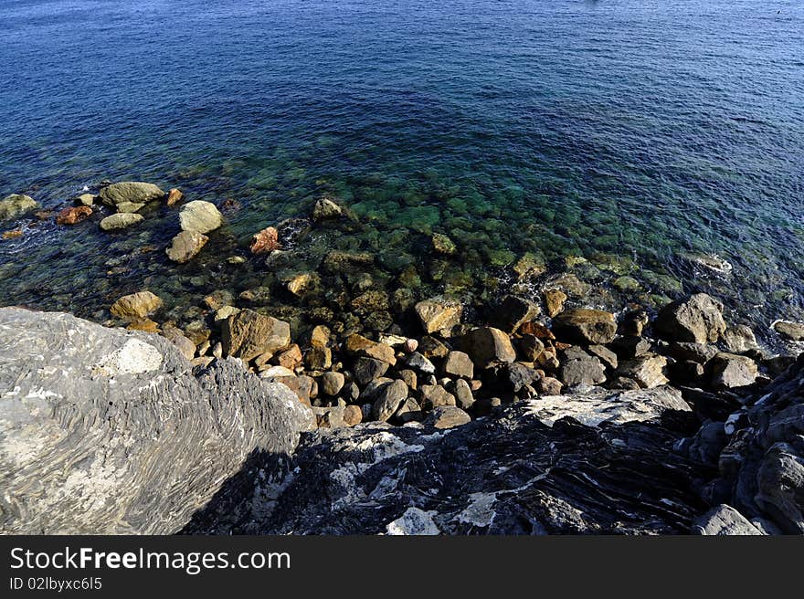 The sea near a beach. It is a sunny day. The sea near a beach. It is a sunny day.