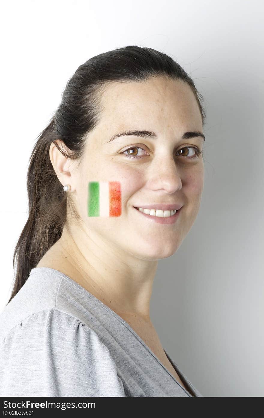 Mexican fan with a painted flag on her face.