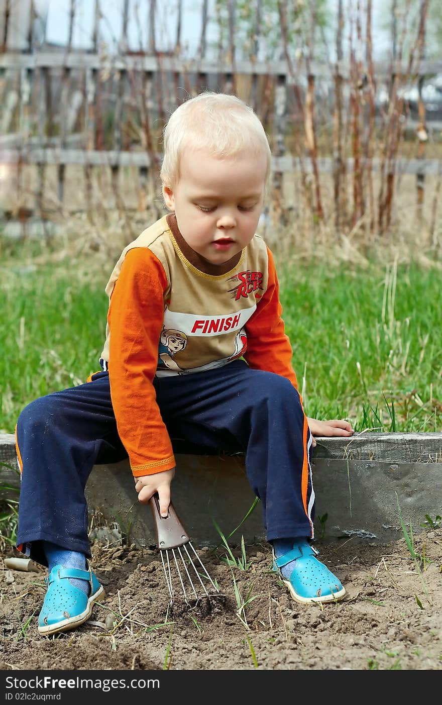 Young Boy digging in the ground