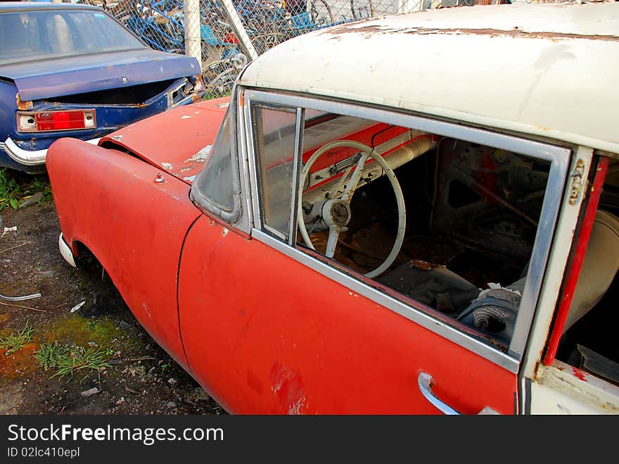 Old rusted American car and junked car. Old rusted American car and junked car