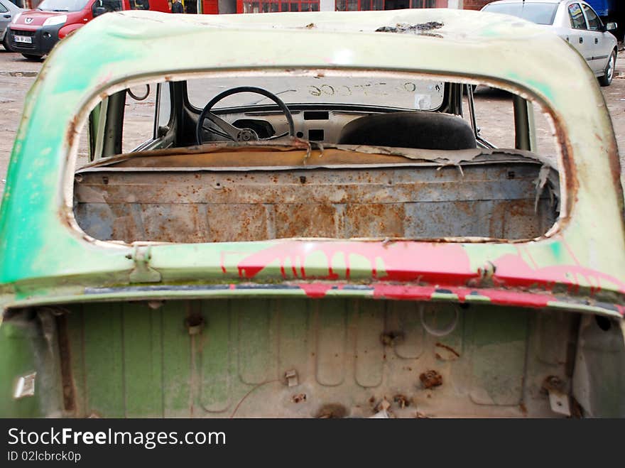 Back of a old abandoned car with broken window. Back of a old abandoned car with broken window.