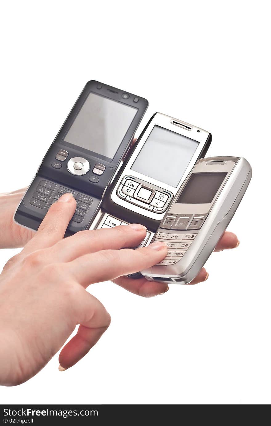 Three mobile phones in woman's hand. Isolated on white background