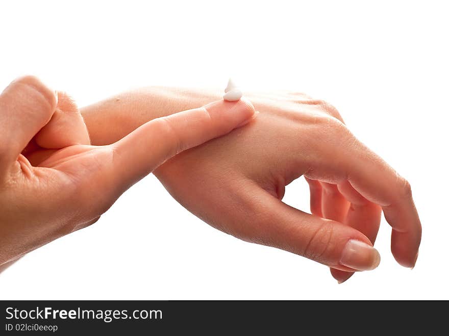 Cream on woman's hand. Isolated on white background. Cream on woman's hand. Isolated on white background