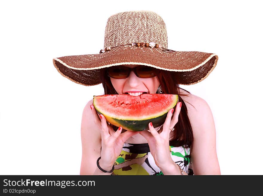 A beautiful woman wearing a hat and sunglasses, enjoying a sweet watermelon. A beautiful woman wearing a hat and sunglasses, enjoying a sweet watermelon.