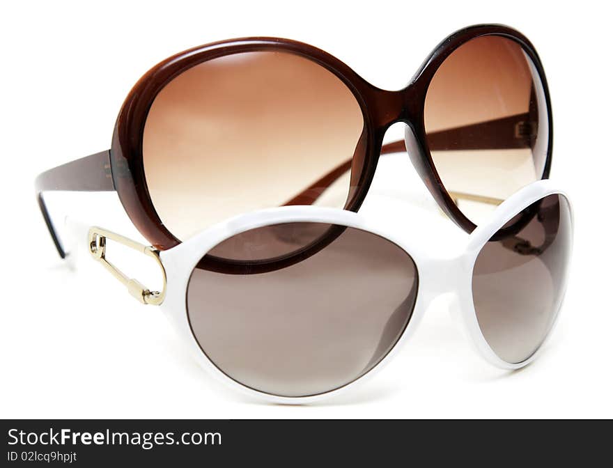 Two sunglasses white and brown on white background