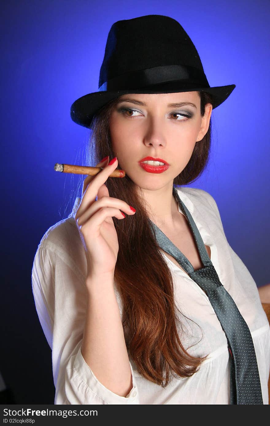 Beautiful young woman smoking cigar. Beautiful young woman smoking cigar