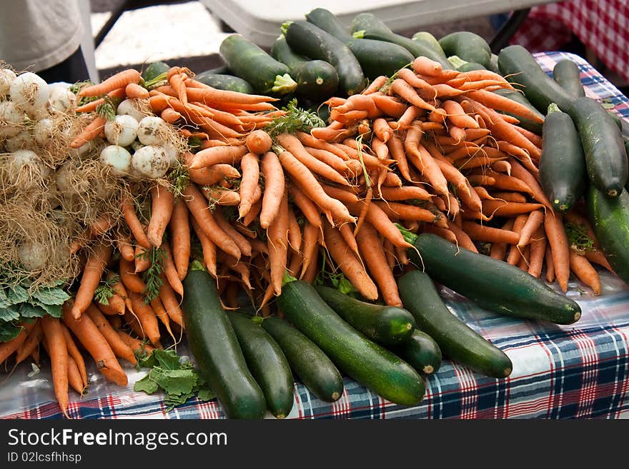 Organic carrots, zucchini, squash, and garlic at the local farmers market. Organic carrots, zucchini, squash, and garlic at the local farmers market