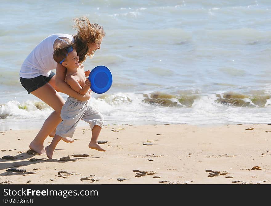 Happy mother and son on beach