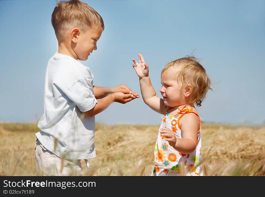 Two kids playing on rural background. Two kids playing on rural background