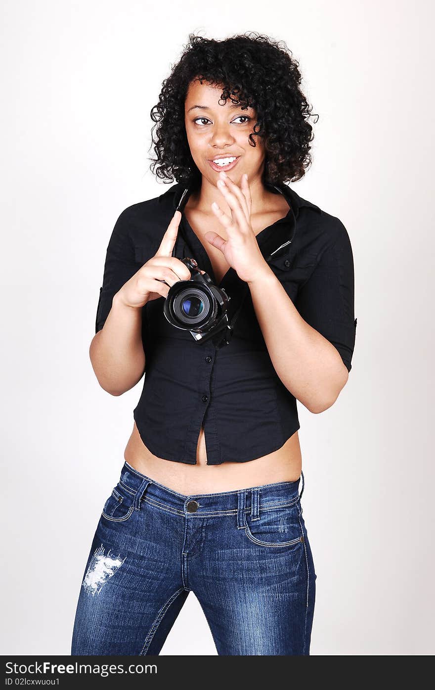 A pretty Hispanic woman looking at her new camera to find the right
setting for the next picture, in a black blouse and jeans, over light gray. A pretty Hispanic woman looking at her new camera to find the right
setting for the next picture, in a black blouse and jeans, over light gray.