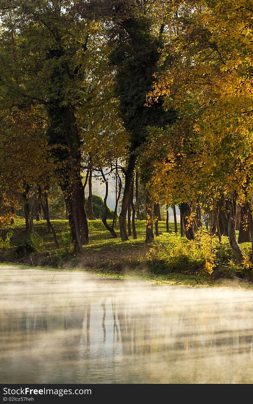 Fog rising over the river in the autumn evening.