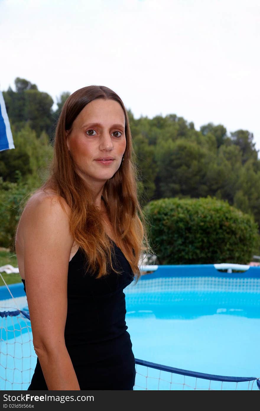 Blond woman standing near the pool. Blond woman standing near the pool