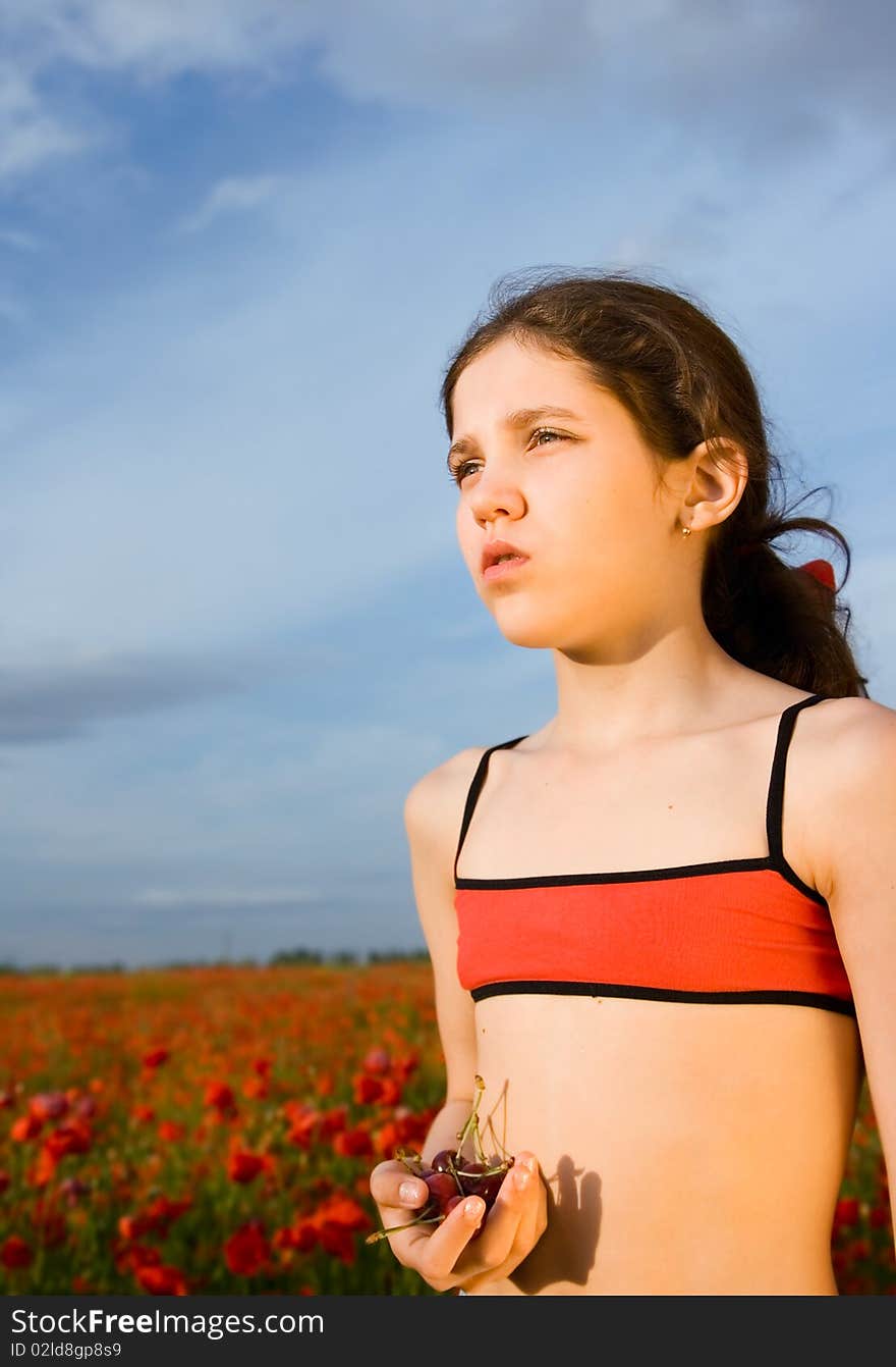 Portrait teen girl with cherry on nature