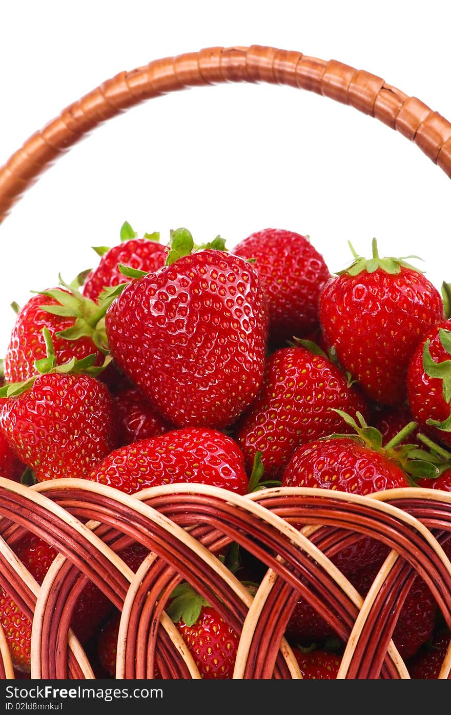 Ripe strawberry in wicker basketbasket isolated on a white background