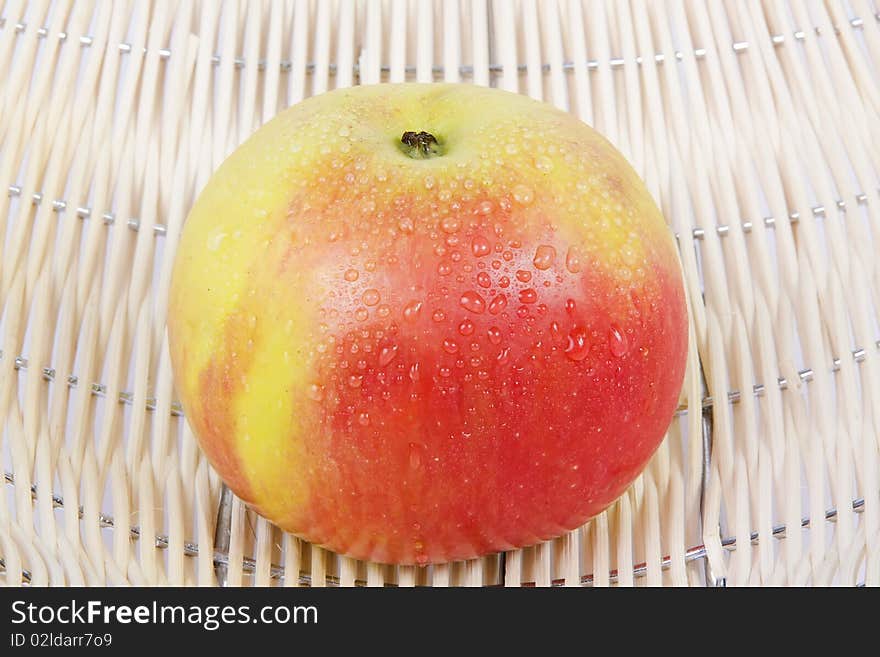 Close-up wet red apple in basket. Close-up wet red apple in basket.