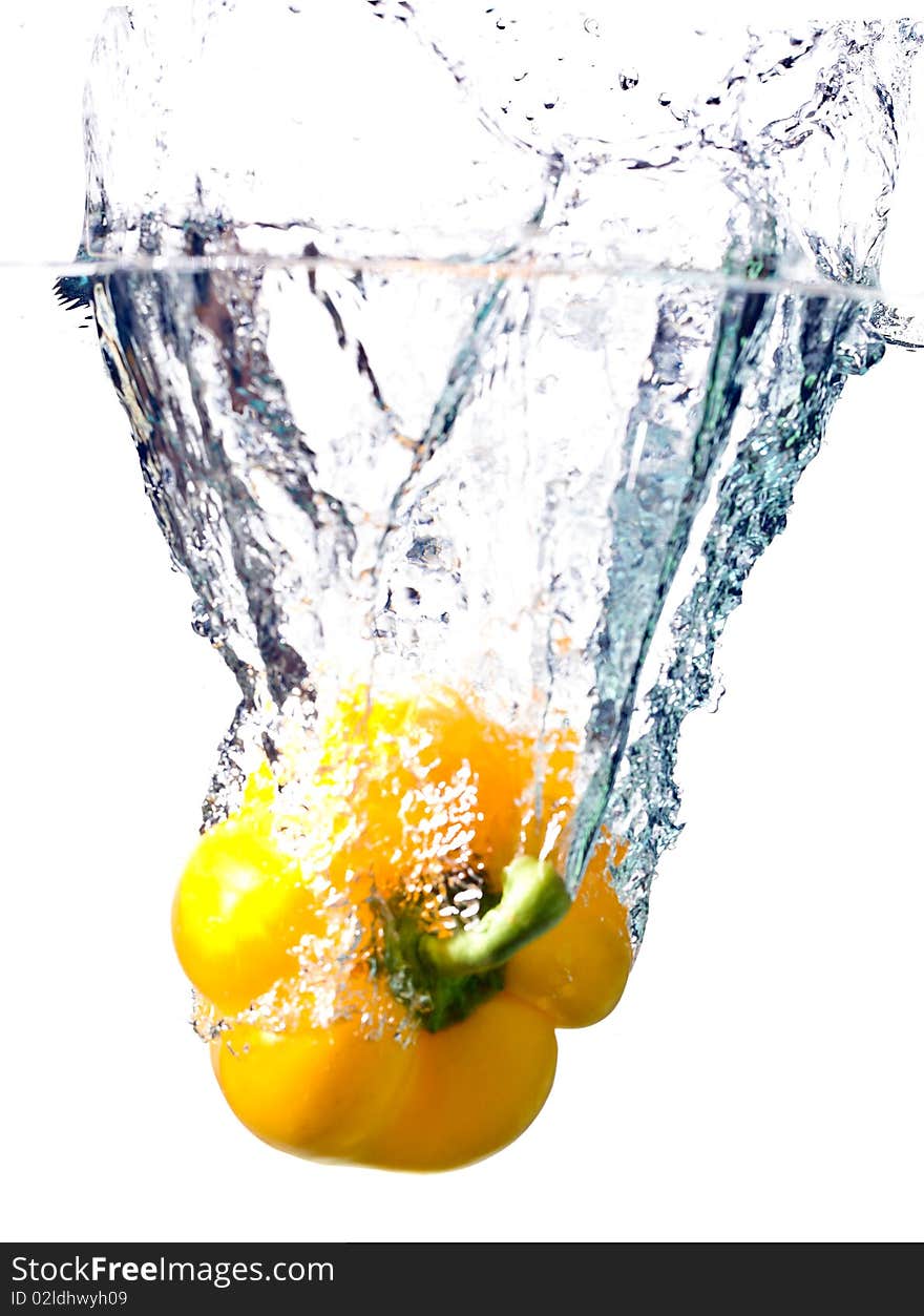 Water splash on yellow pepper isolated on white. Water splash on yellow pepper isolated on white