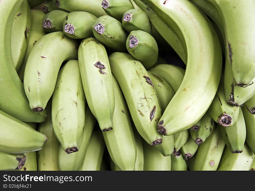 A background of a pile of green organic bananas. A background of a pile of green organic bananas