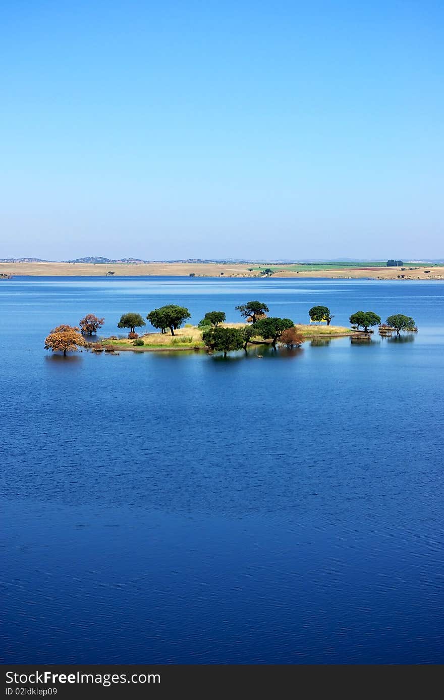 Island in blue Lake, Alentejo, Portugal. Island in blue Lake, Alentejo, Portugal.