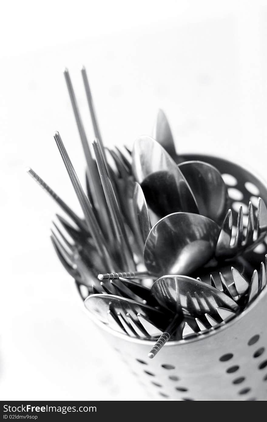 Forks, Spoons and chopsticks in the silver basket on white background